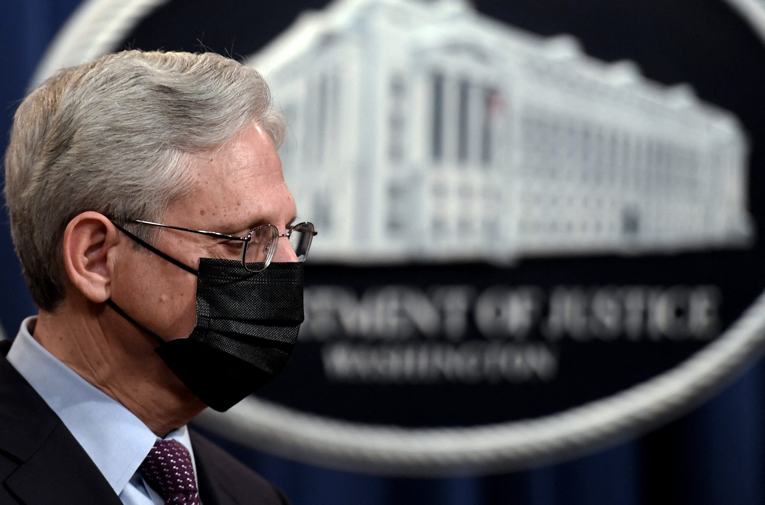 Attorney General Merrick Garland listens during a news conference over ransomware cyberattacks, at the Department of Justice, in Washington, DC on November 8, 2021.