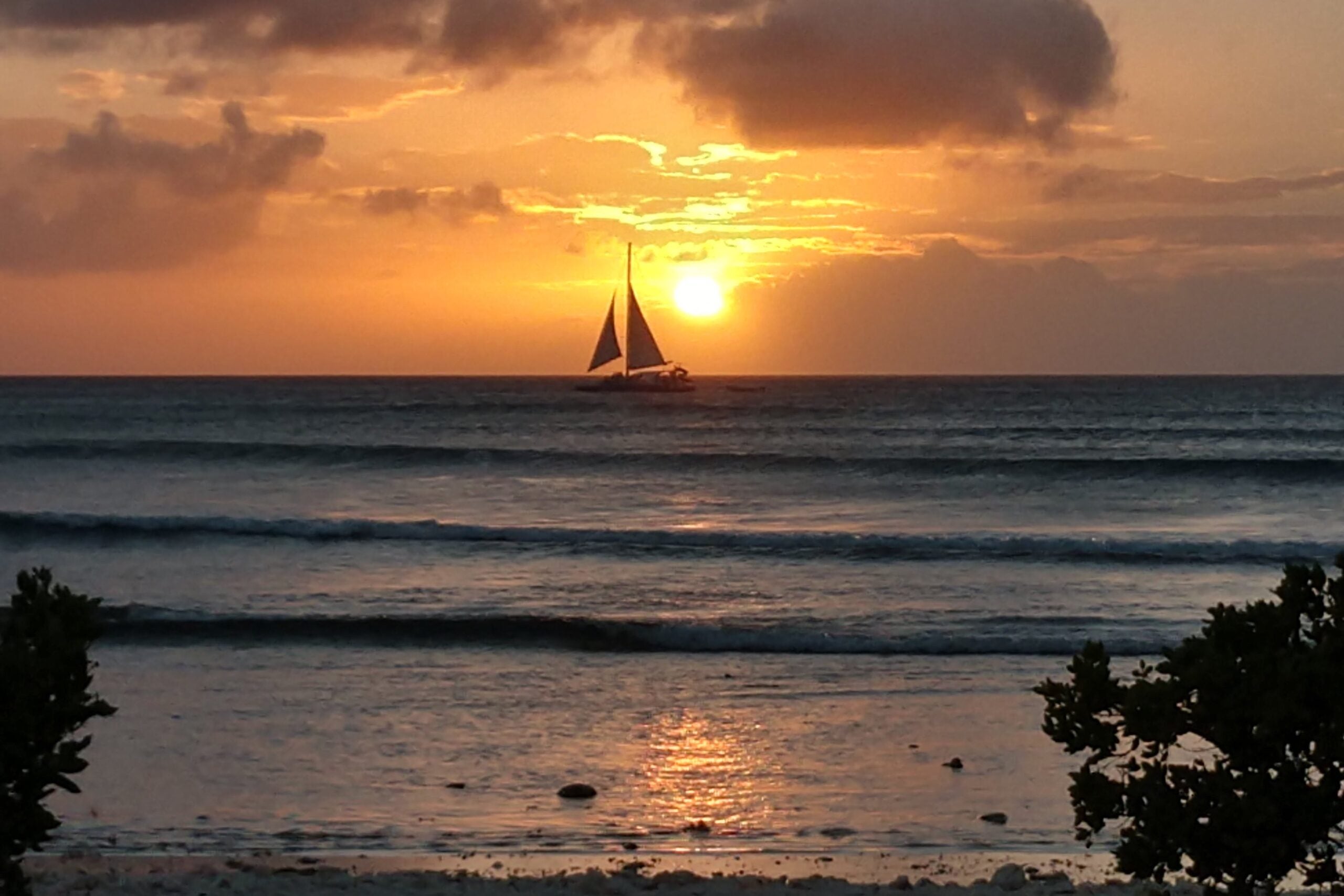 A sunset with sailboat silhouette in Aruba