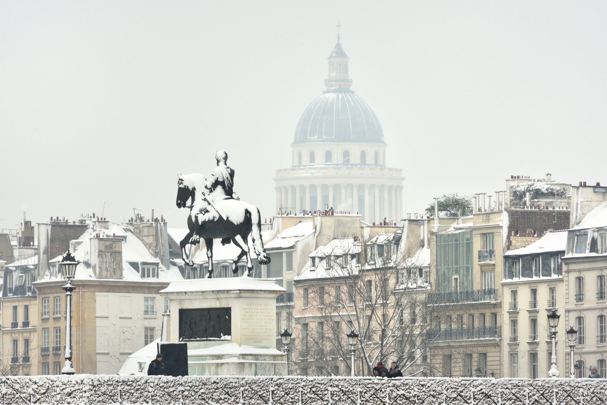 France, Paris, Pont Neuf, Equestrian statue of Henri IV and Pantheon dome in winter
