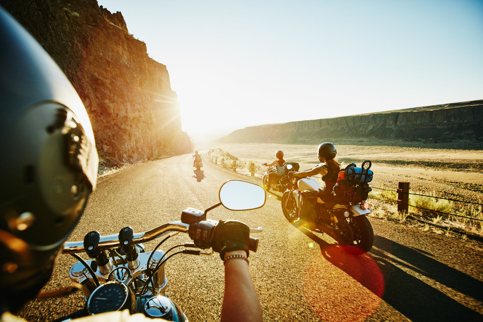 Group of female bikers riding near the ocean.