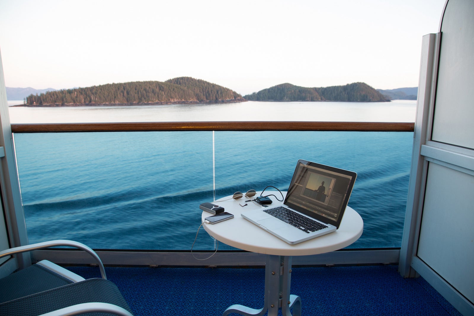 View from cruise ship with laptop on table, Alaska, USA