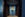 blue walls with two brown hotel doors and art