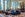 hotel lounge with tile floors, couches, large grandfather clock and floor-to-ceiling windows