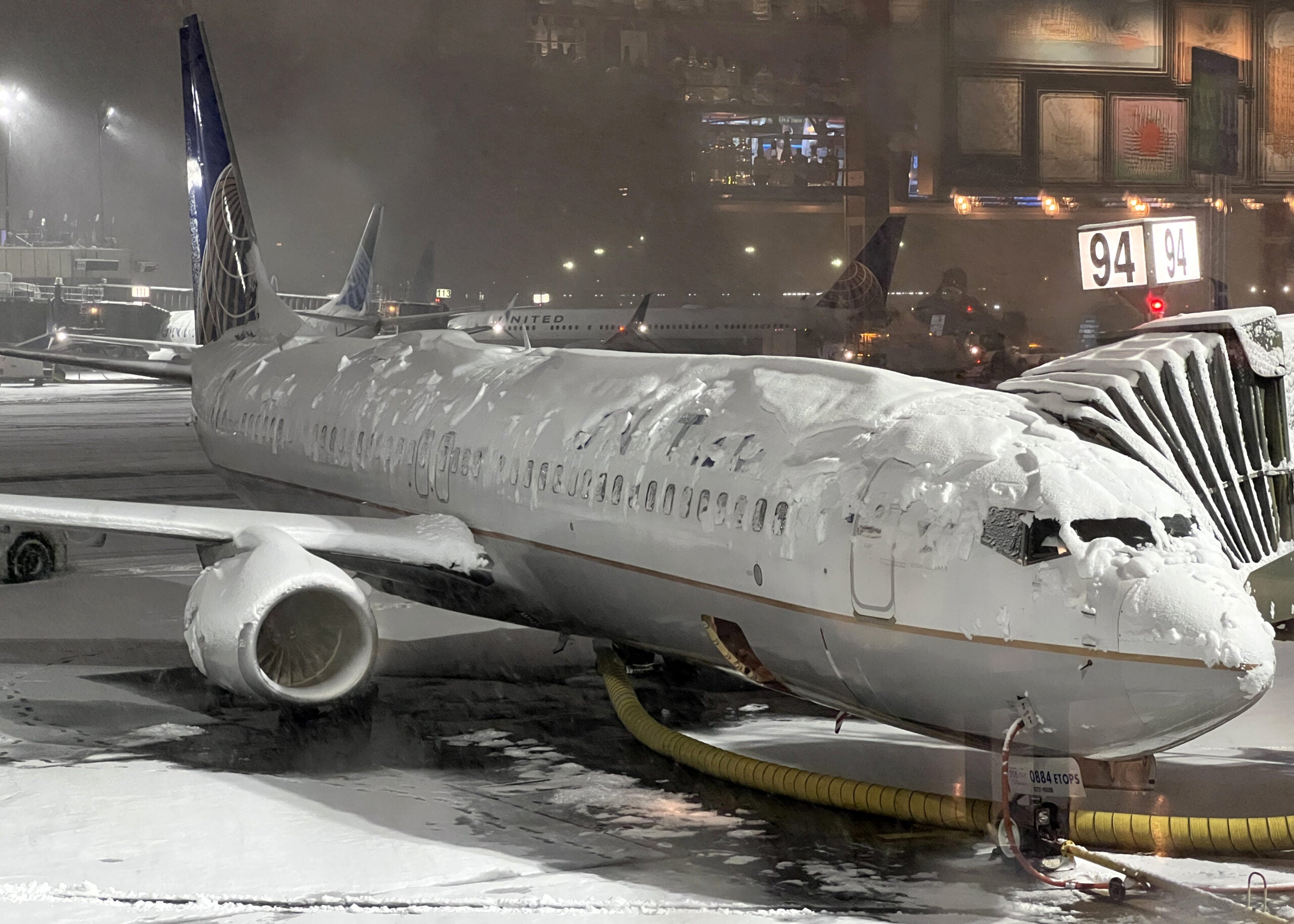 NEW JERSEY, USA - JANUARY 07: A United Airlines plane is seen as runway covered with snow at Newark Liberty International Airport on January 7, 2022 in New Jersey, United States as massive snow storm hits the east coast. (Photo by Tayfun Coskun/Anadolu Agency via Getty Images)