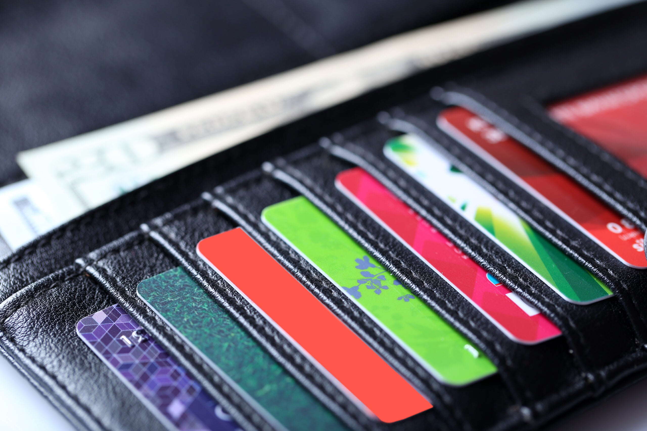 a generic image of credit cards lined up in a black leather billfold