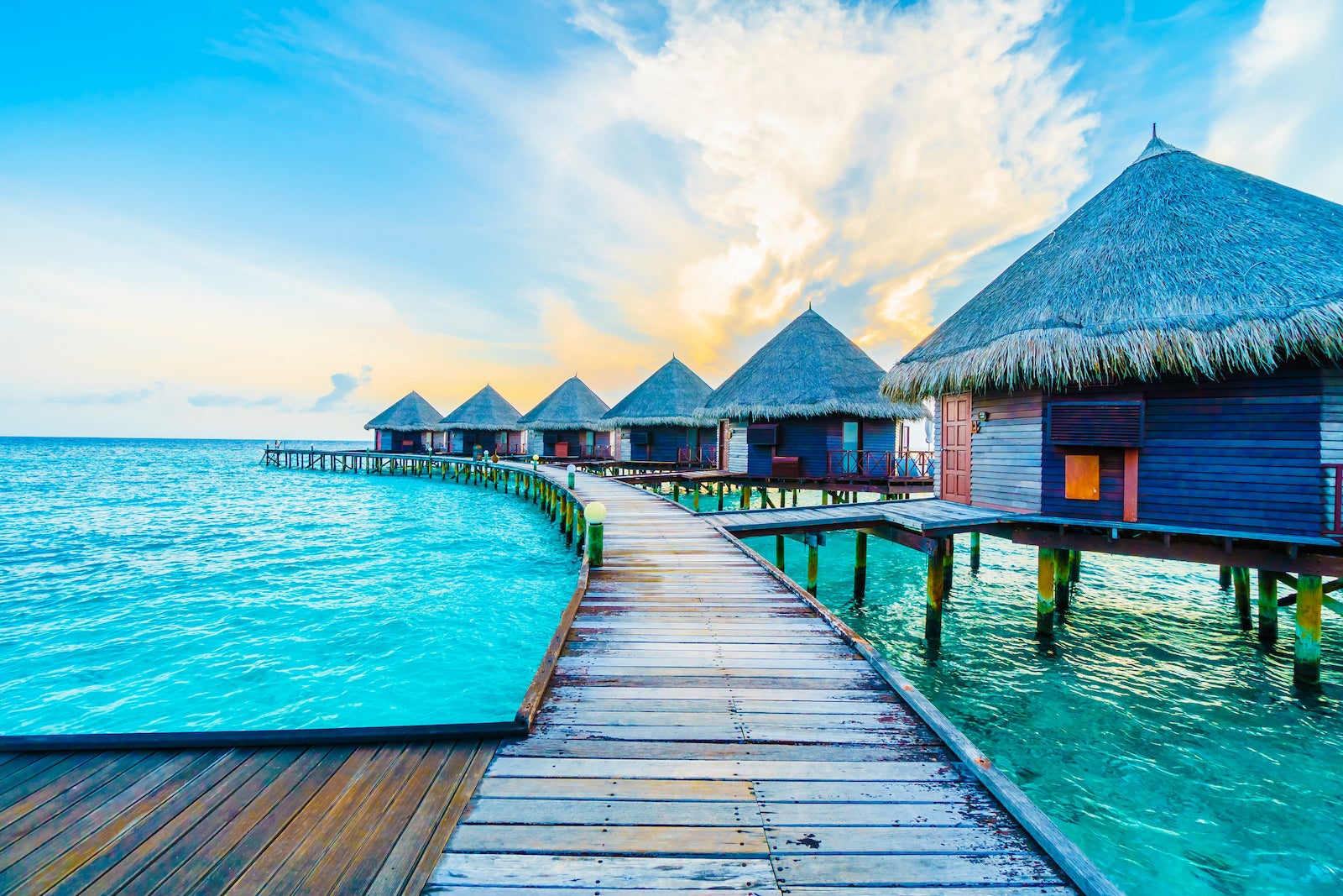 view over overwater bungalows in The Maldives over turquoise blue water