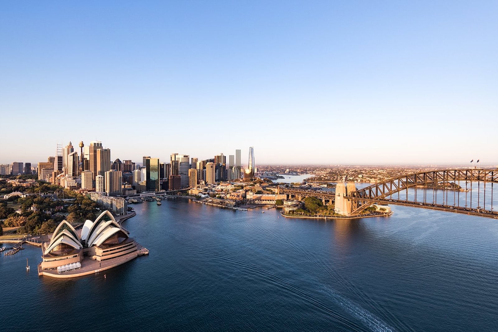 aerial view of Sydney harbor with Opera house and bridge in the distance