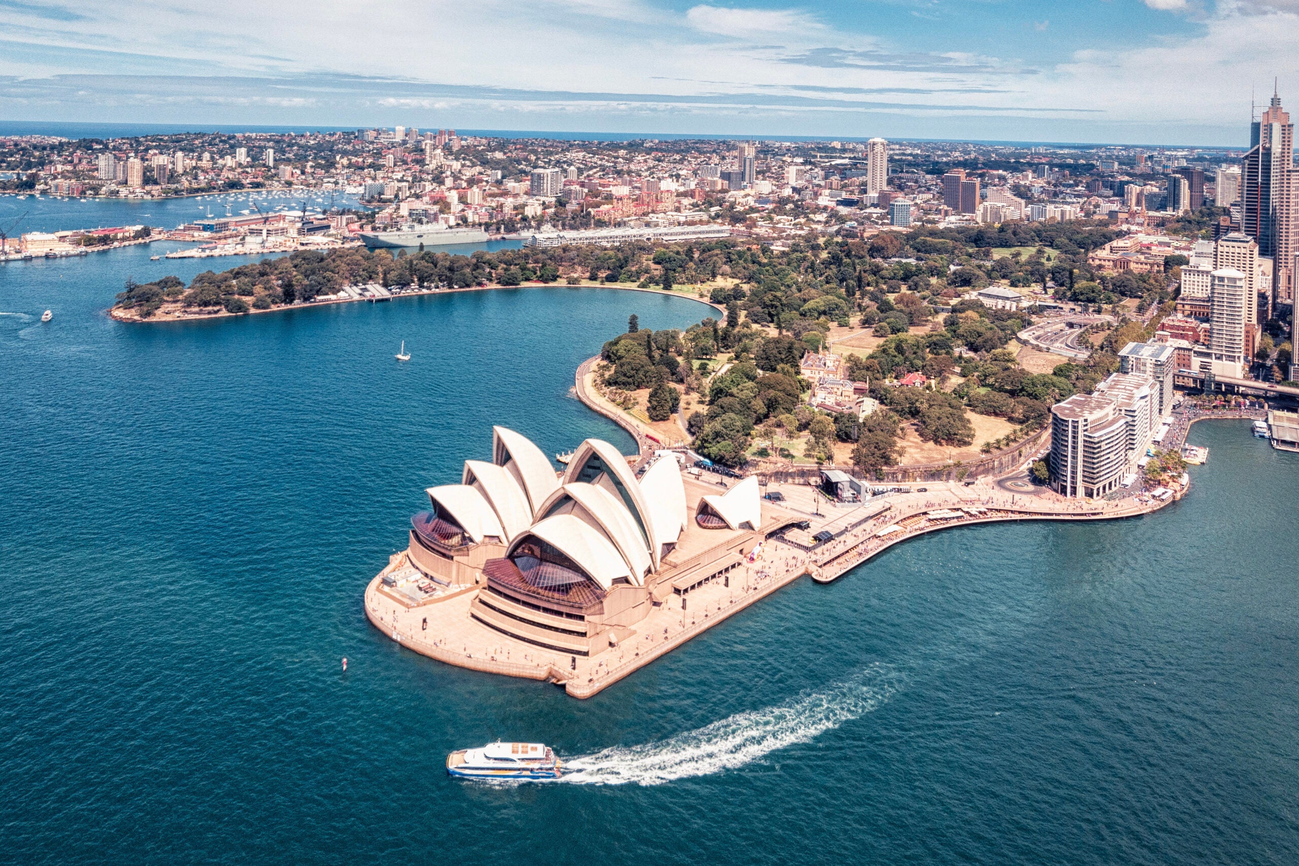 drone photo of the Sydney Opera house and city center with skyscrapers and buildings.