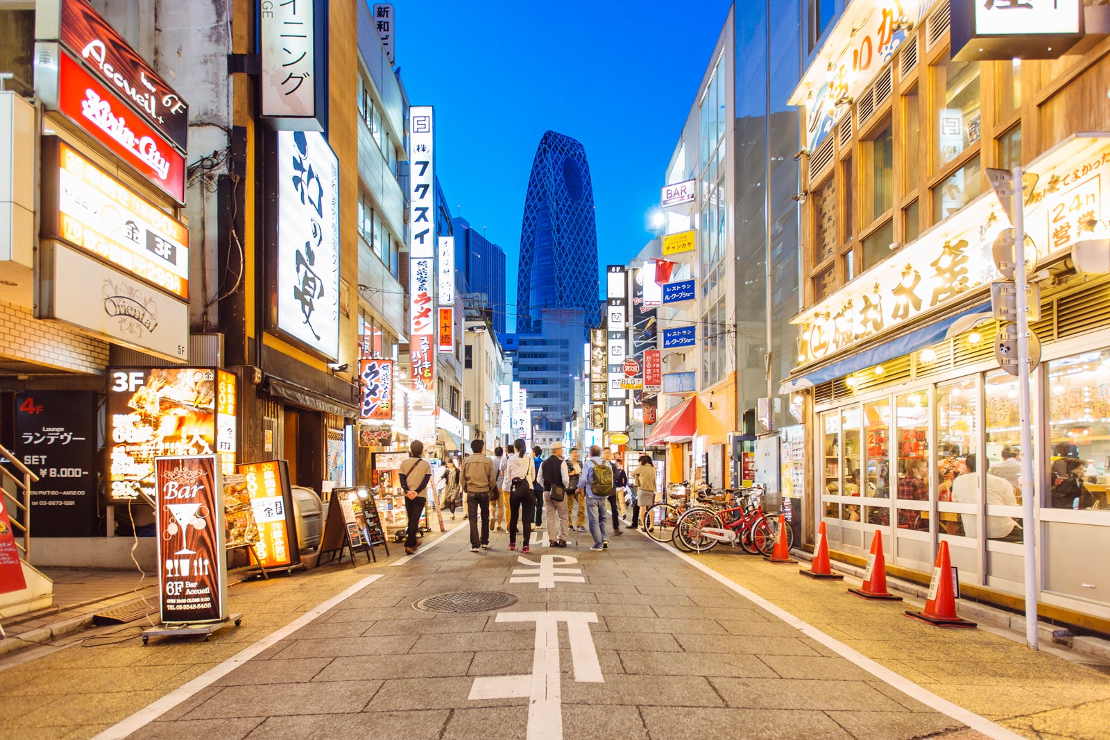 Street with shops and restaurants in Shinjuku district in Tokyo, Japan