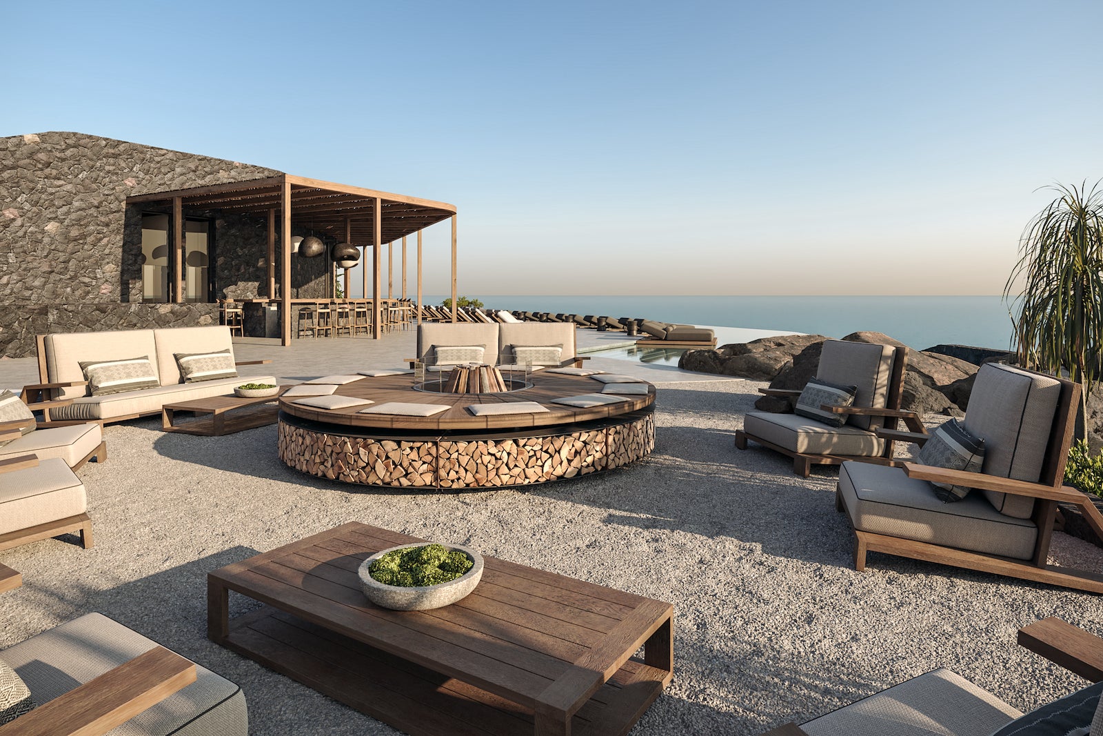 fire pit with chairs around it and view of the ocean