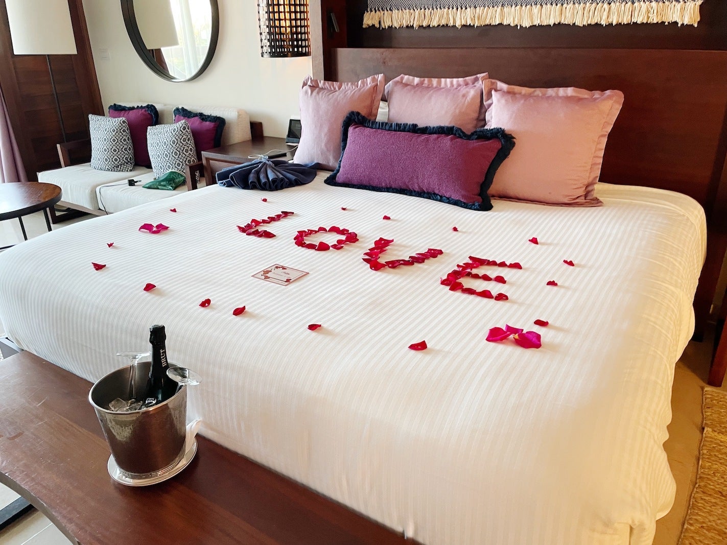 bed with rose petals spelling love