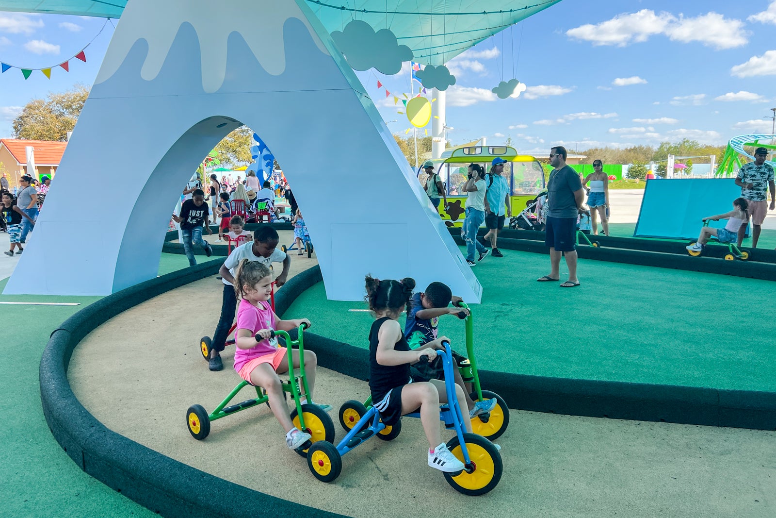 Children riding tricycles at Peppa Pig Theme Park