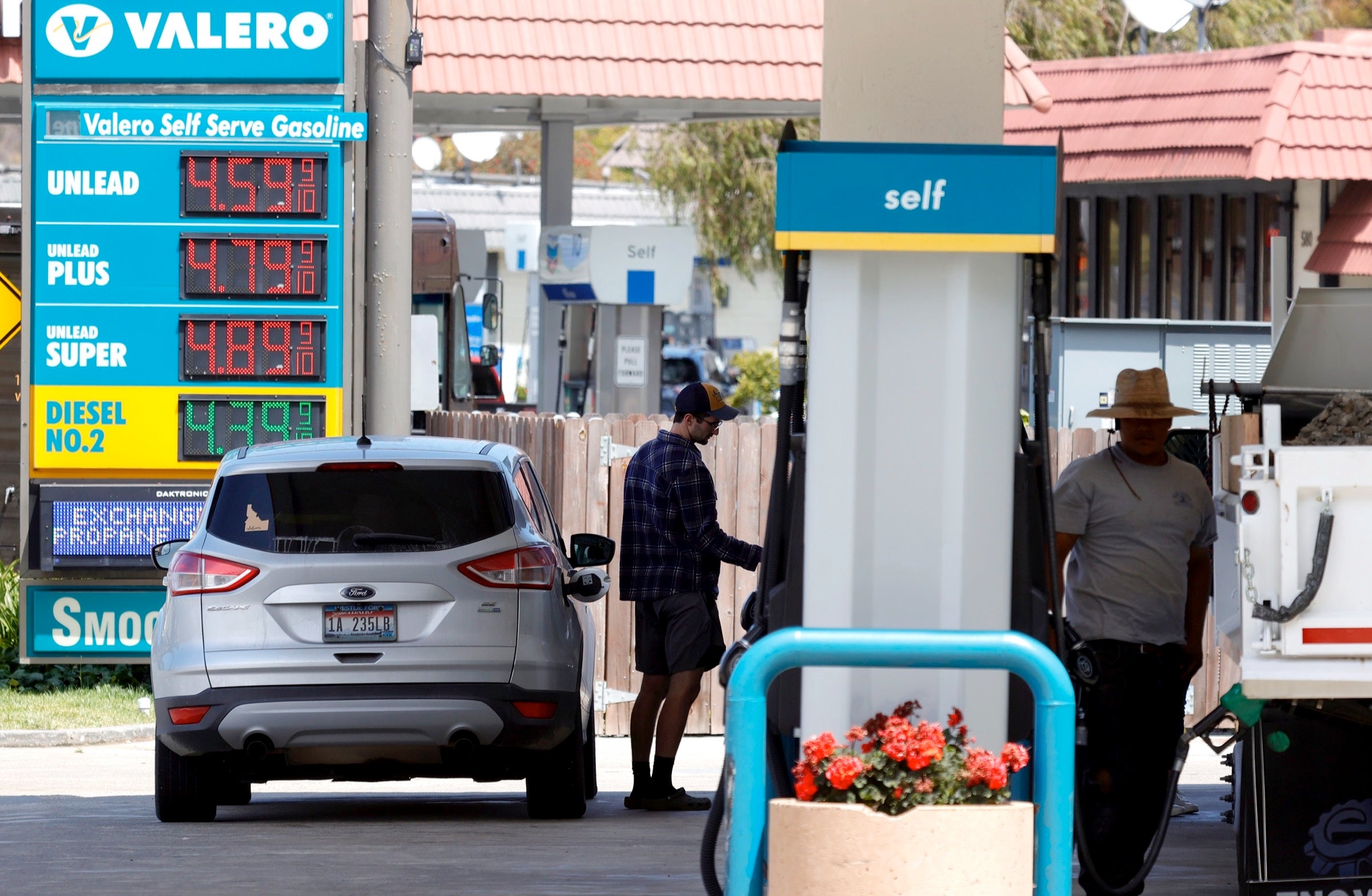 Drivers pumping gas at a Valero gas station in California