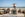 Tourists pose by the ocean at Cape Agulhas, South Africa