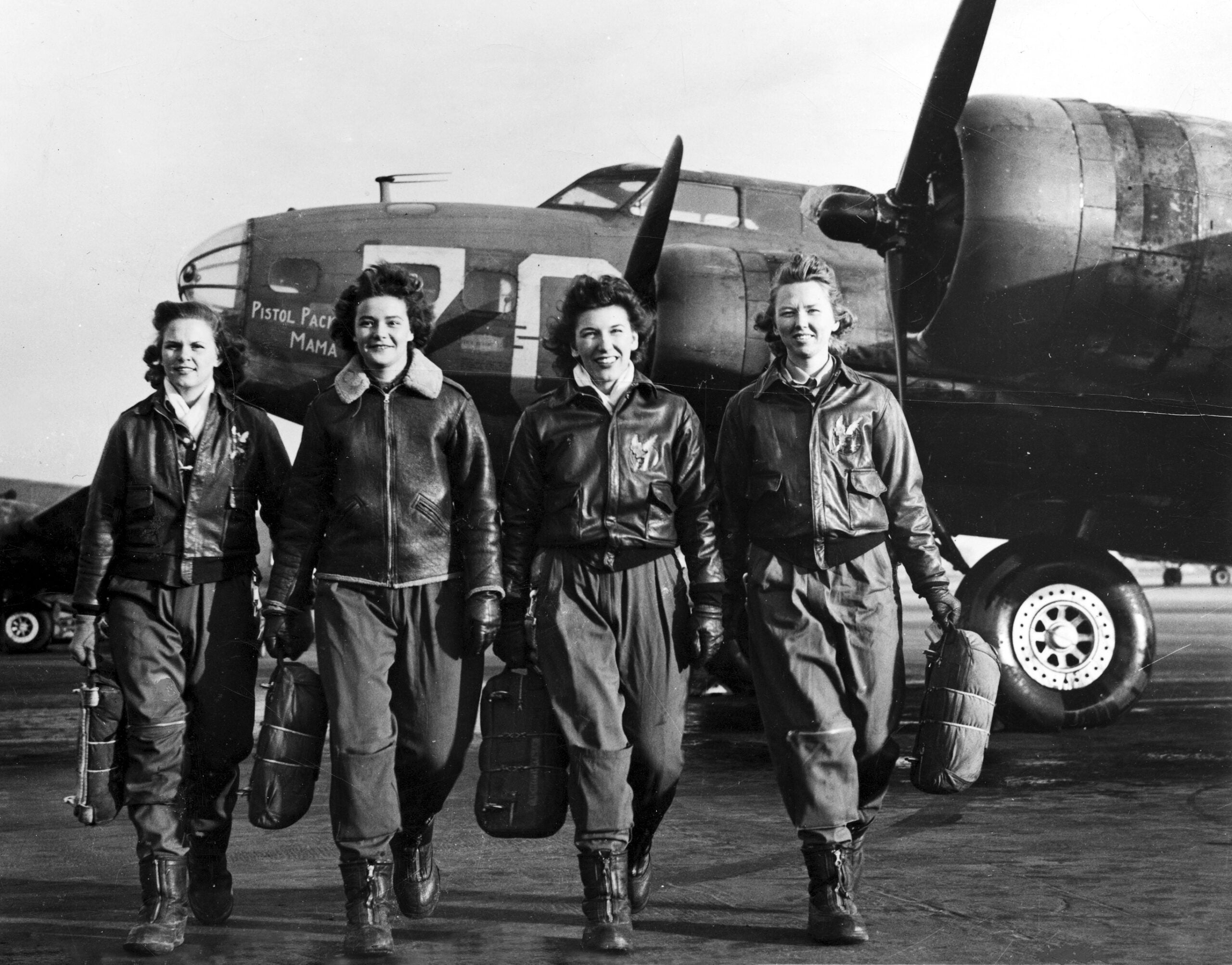 Women Airforce Service pilots Frances Green, Margaret 'Peg' Kirchner, Ann Waldner and Blanche Osborn, leave their B-17 Flying Fortress aircraft, 'Pistol Packin' Mama,' during ferry training at Lockbourne Army Airfield, Ohio, 1944