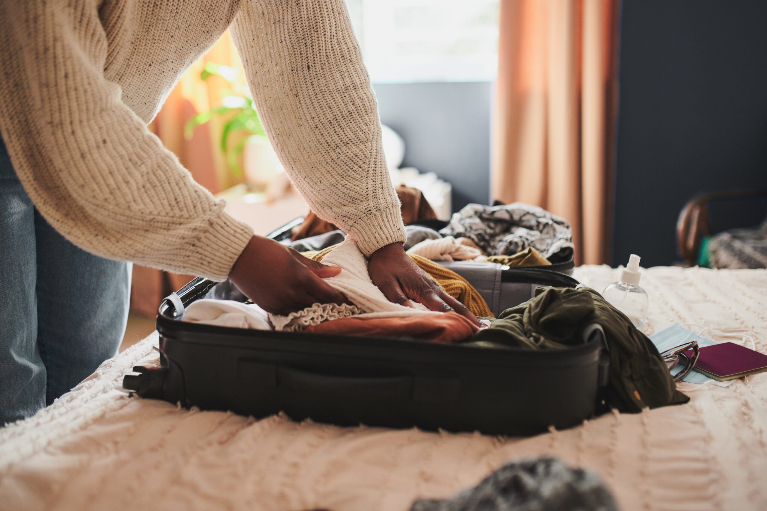 Woman packing small suitcase