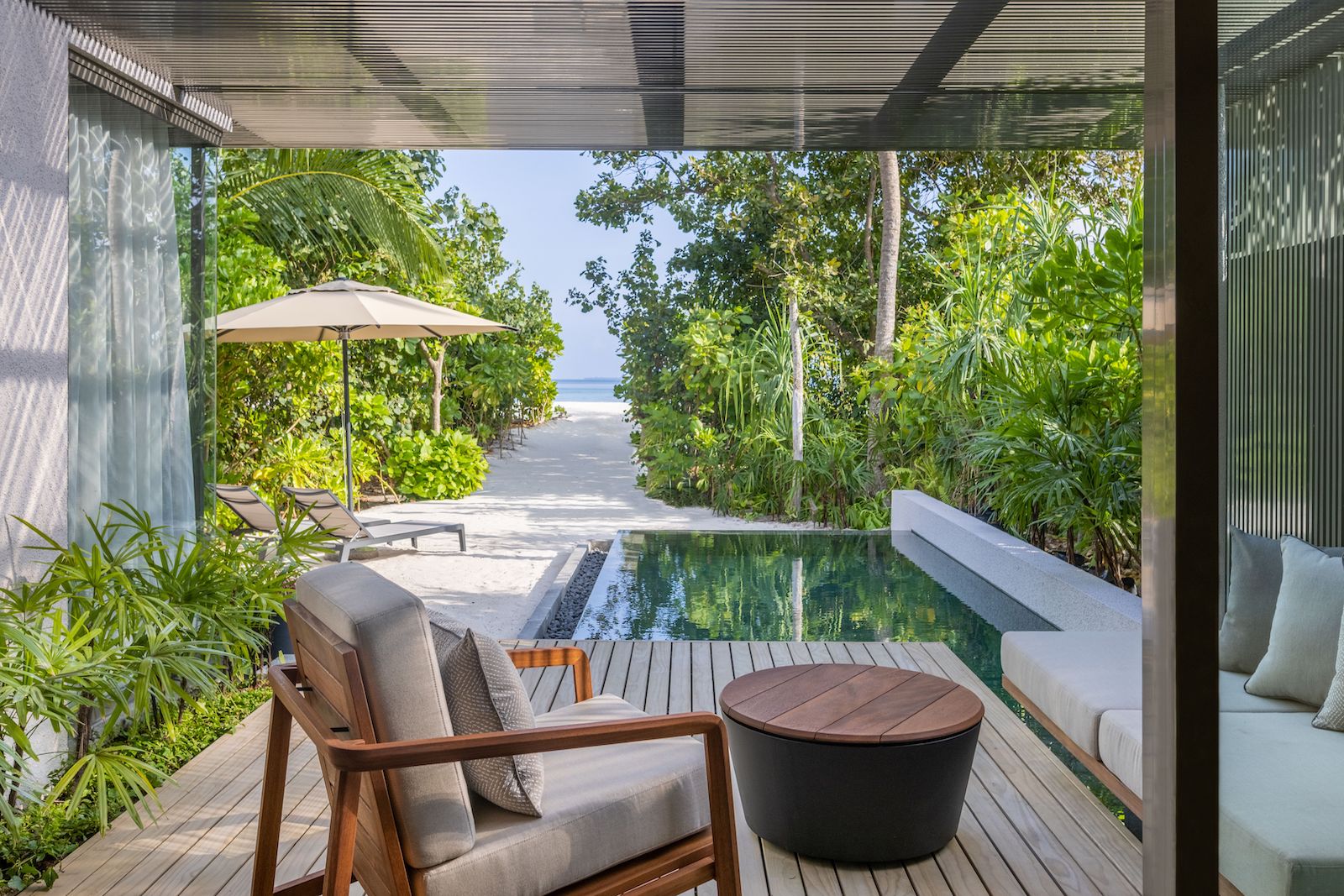 plunge pool near beach with chairs and lounge chairs