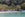 Swimmers in water at Labadee's Columbus Cove beach with lush greenery in the background