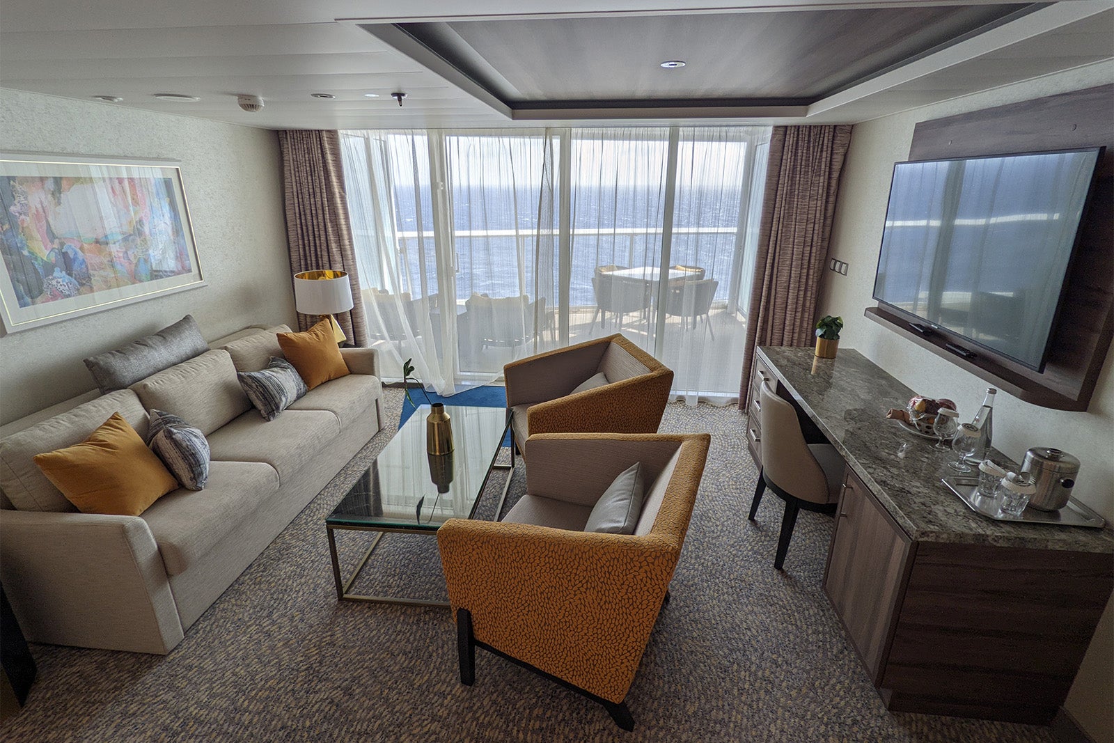 Living room and balcony of cruise ship suite