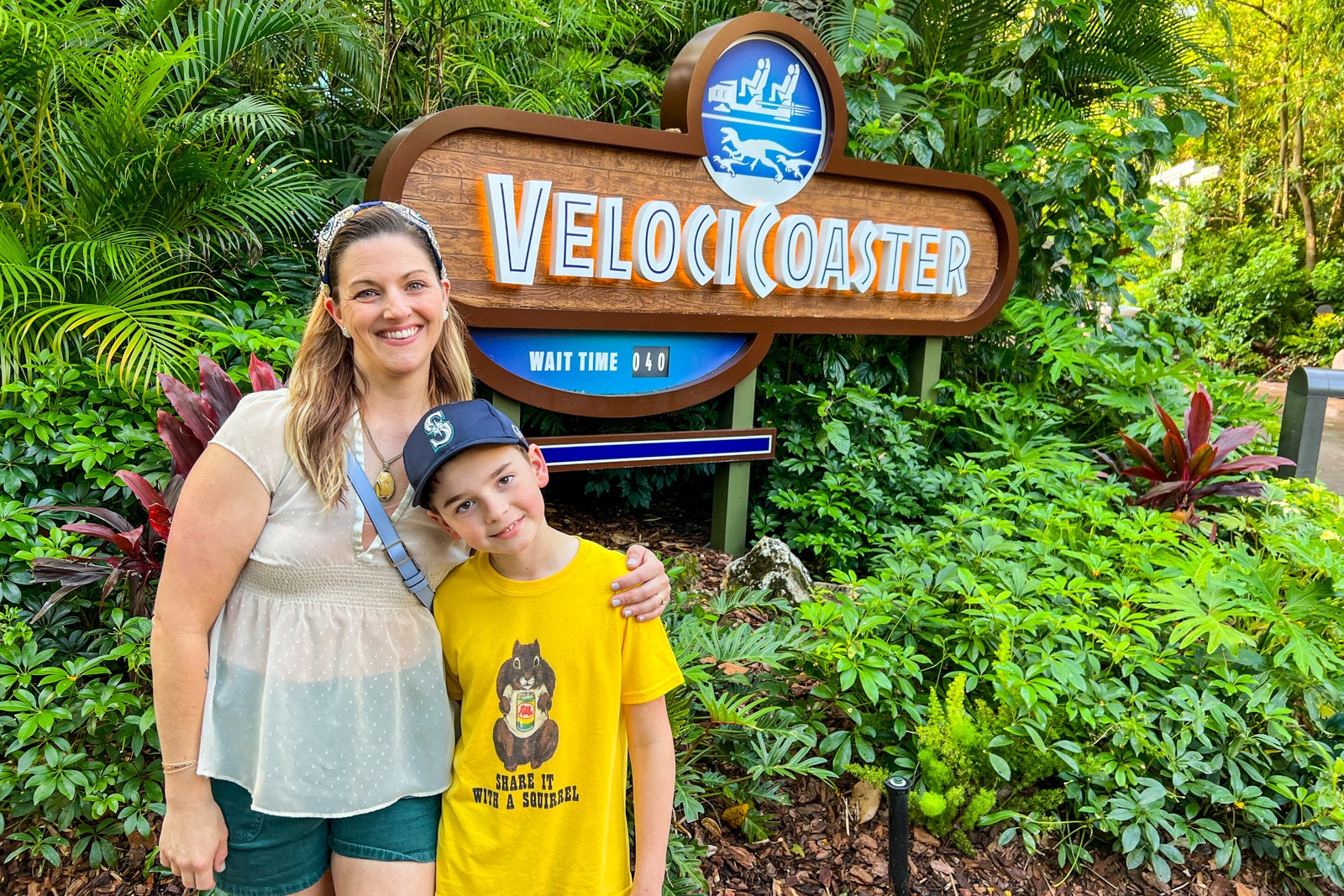Child and mom standing outside roller coaster entrance