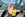 Child and mom standing in front of roller coaster