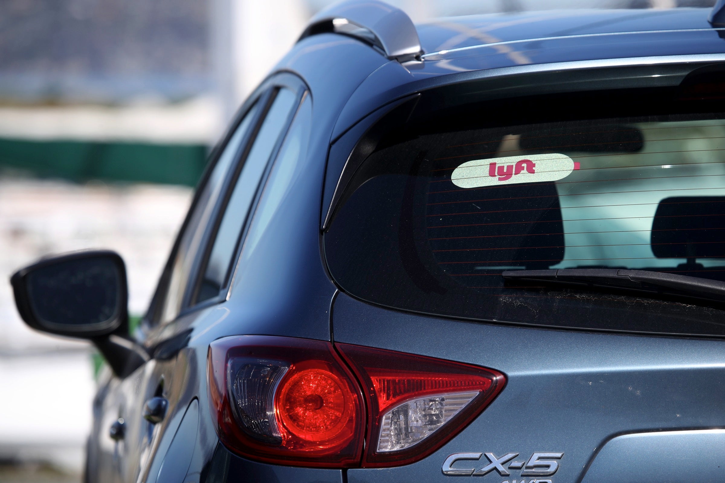 Car with a Lyft sticker in the rear windshield