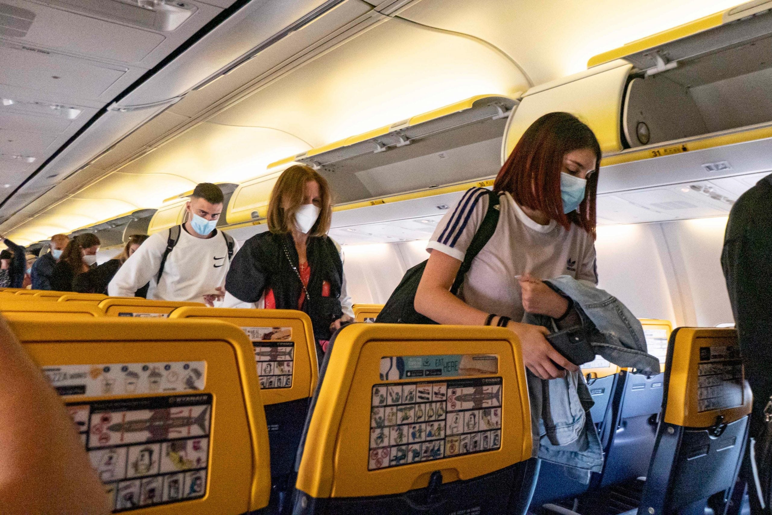 People leaving Ryanair flight wearing masks