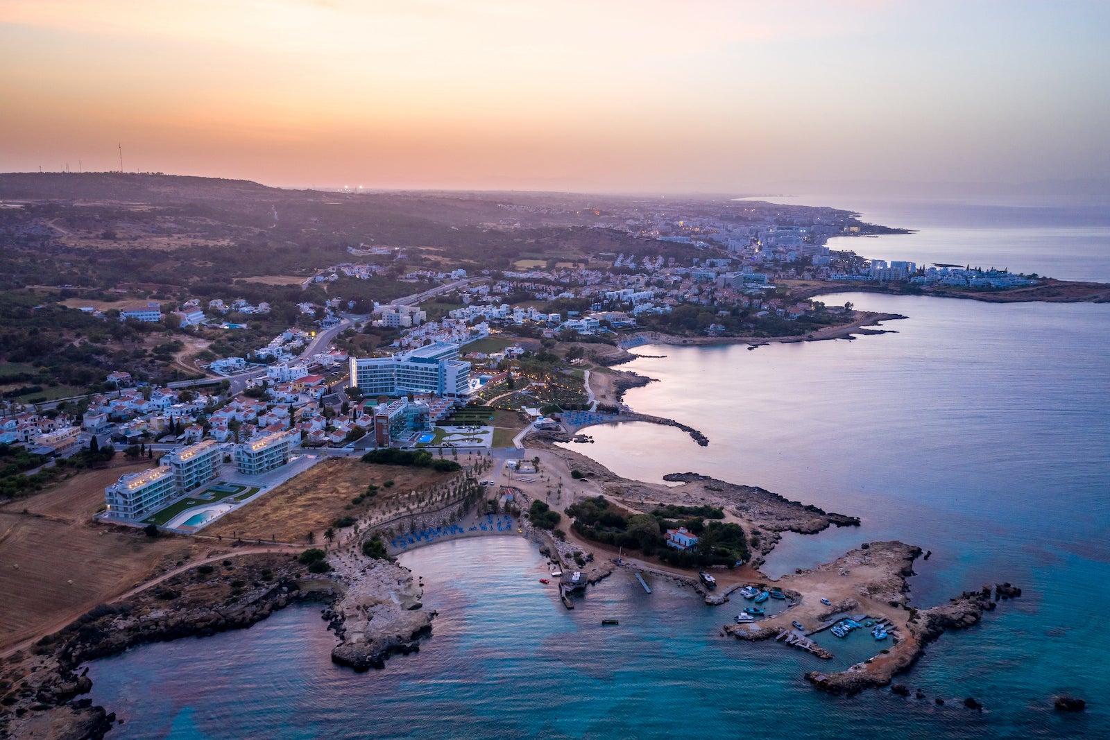 Panoramic view from above to Protaras. Coastline at sunset. Hotels and tourist infrastructure in Cyprus. Cape Capo Greco