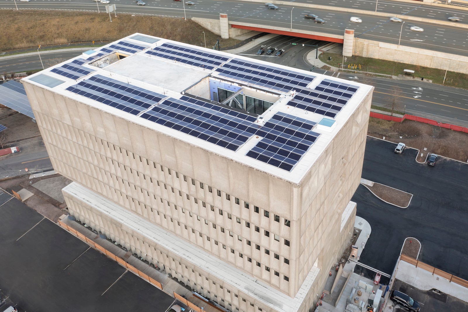 large concrete building with solar panels on the roof