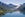 rendering of futuristic, circular hotel over water surrounded by fjords