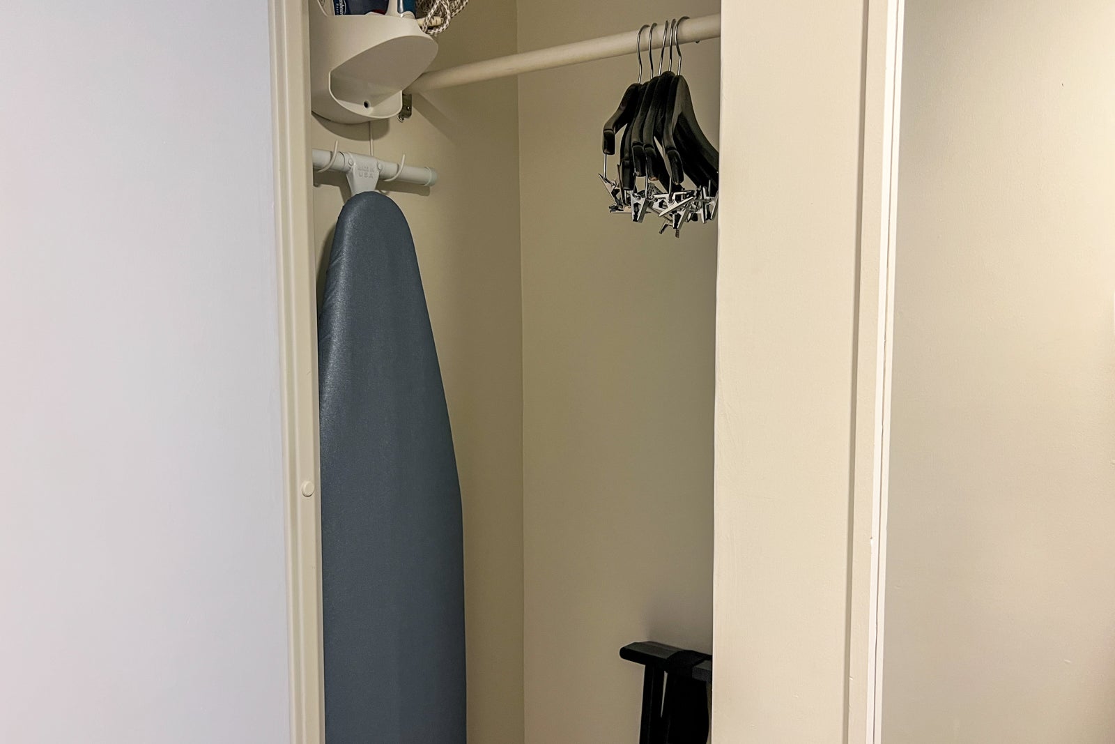Hotel closet with iron and ironing board