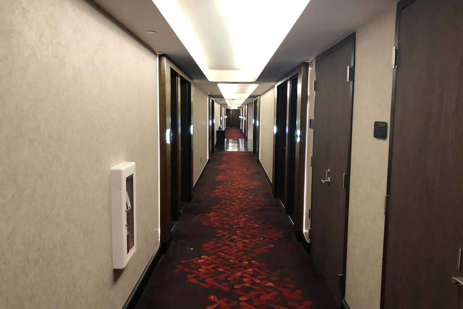 Midcentury modern details like curved ceiling accents and bold pops of red in the carpet greet you when you walk down the hall to The Watergate Hotel's Scandal Room.