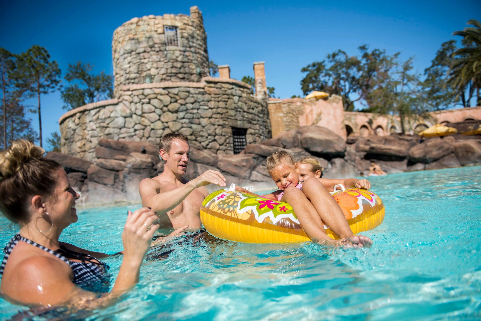 Family playing in pool