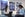 two women on a sofa chat while one uses a laptop and the other writes in a notebook; there are American Express posters on the wall behind them