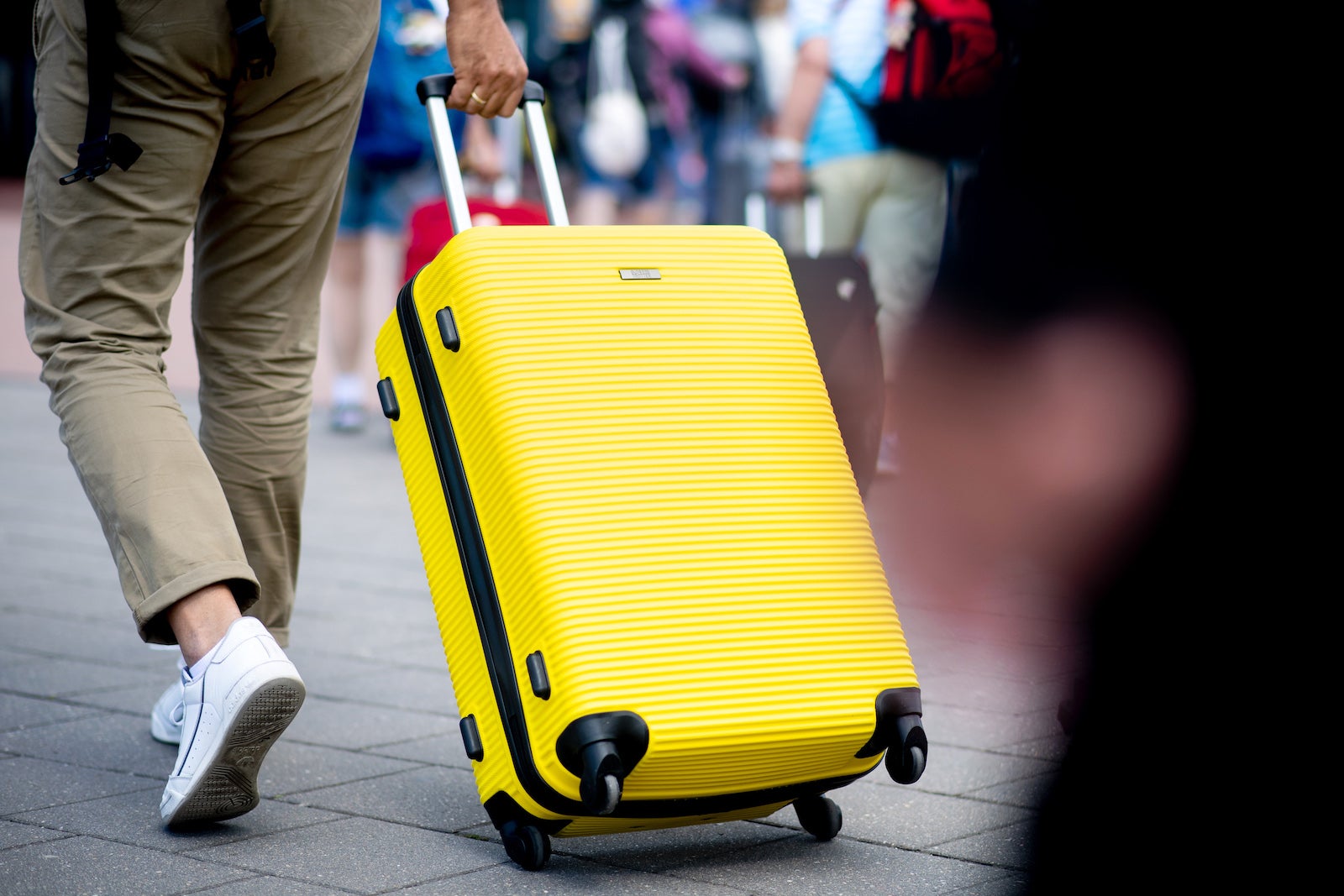 yellow suitcase rolling