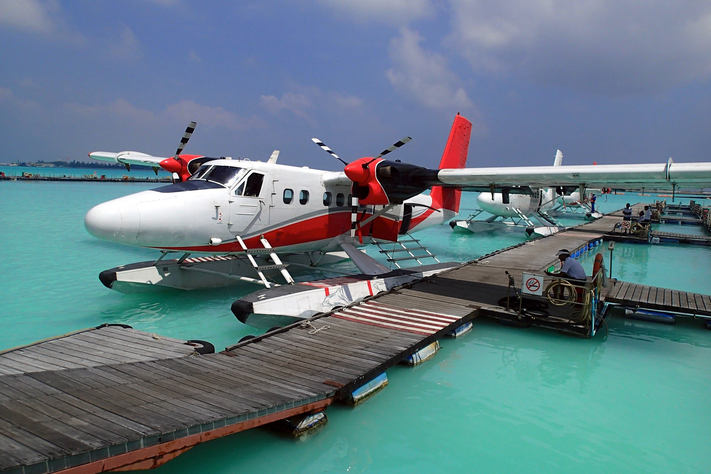 A red and white seaplane docked in the Maldives