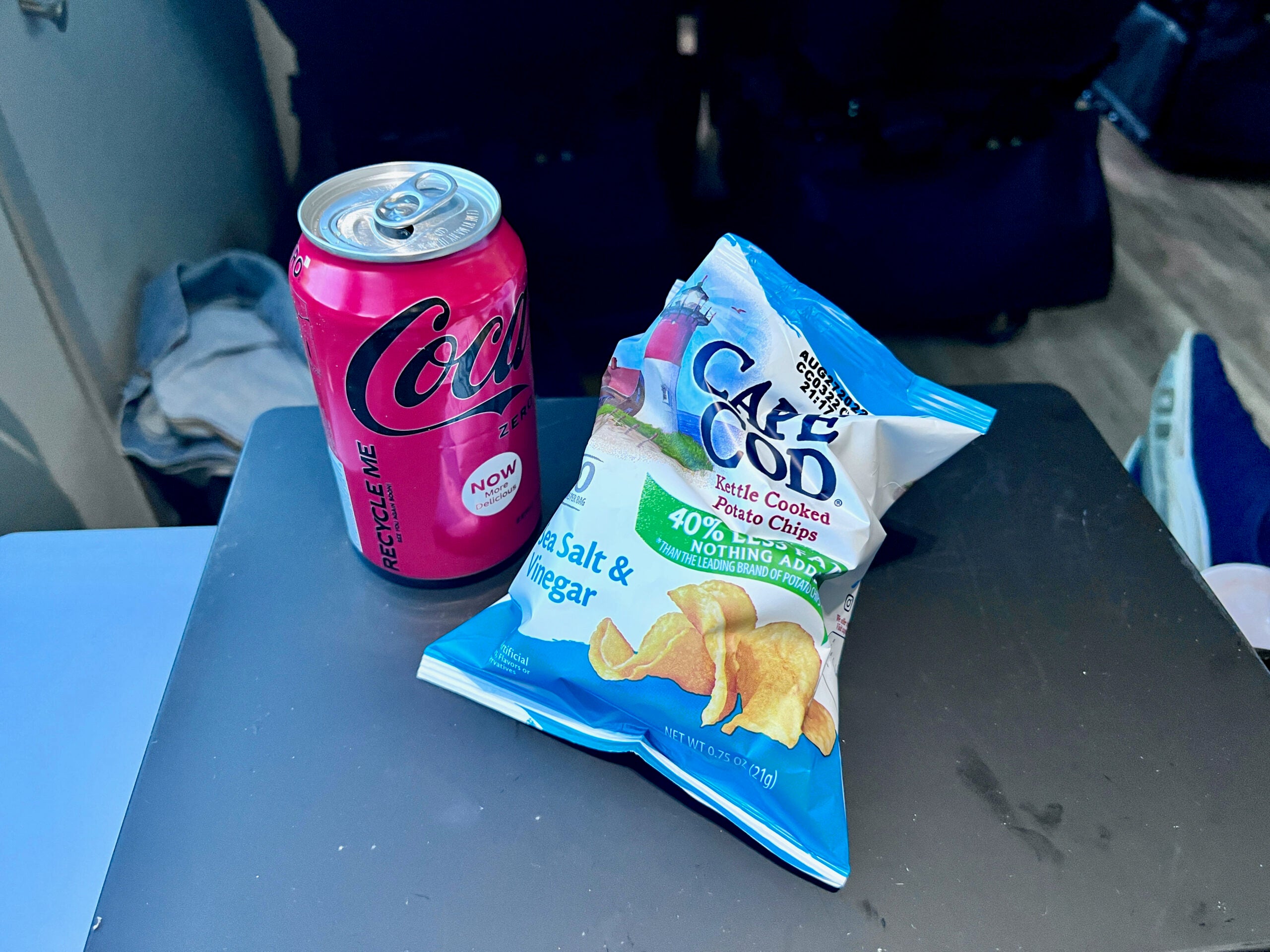 Can of soda and bag of chips on The Jet
