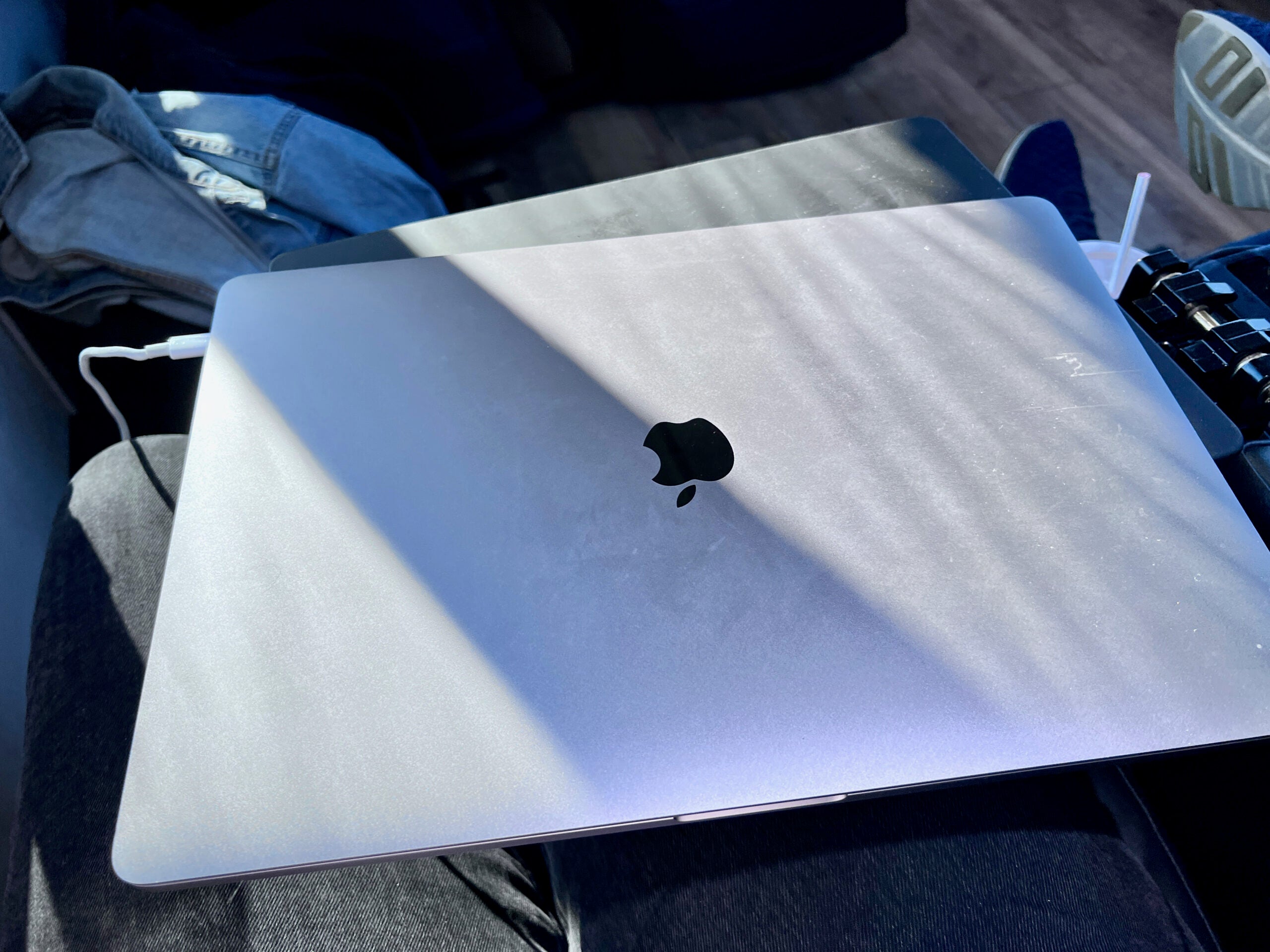 Closed MacBook Pro on bus table