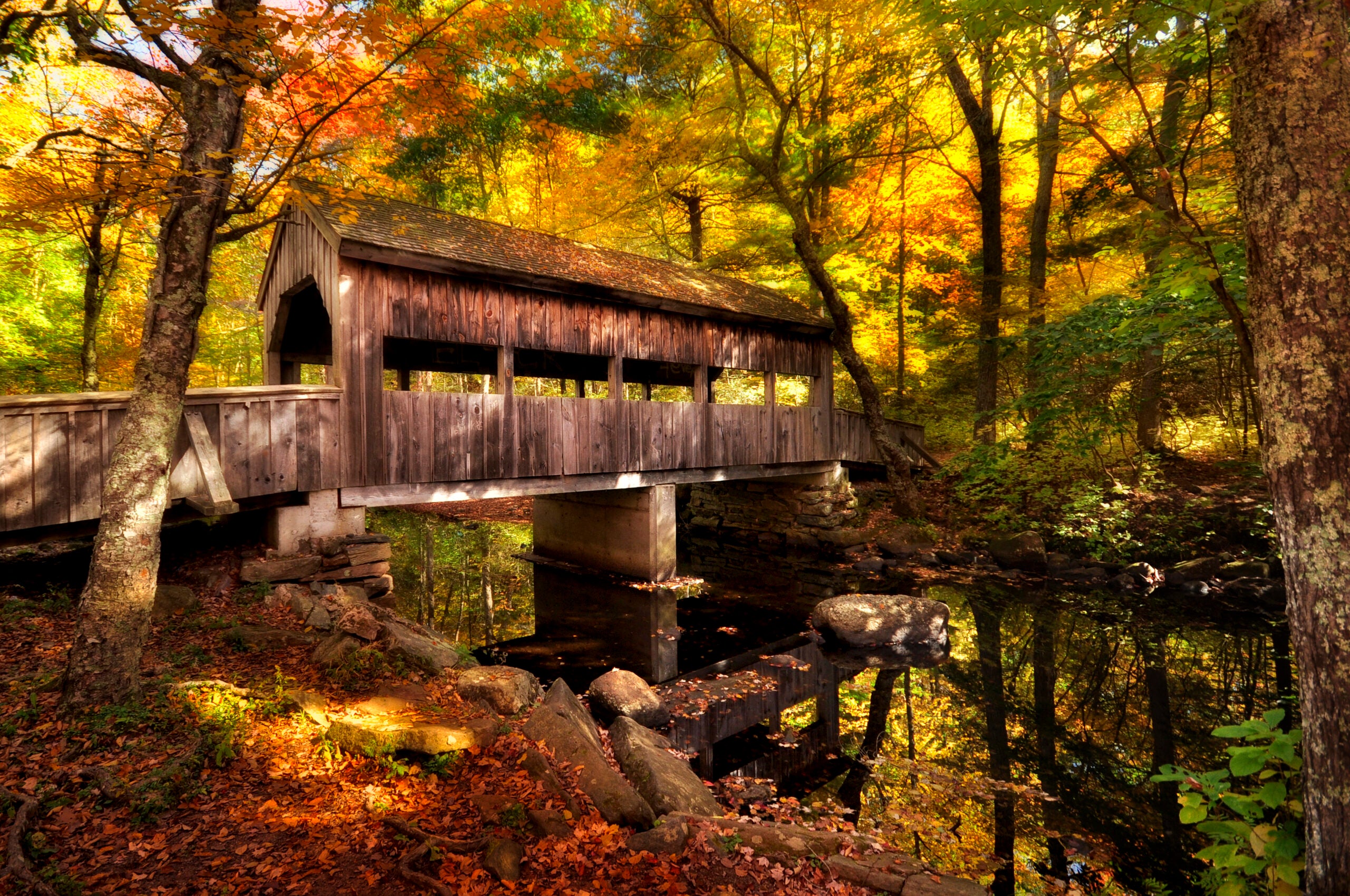 Fall view of a covered bridge in Devil's Hopyard State Park.
