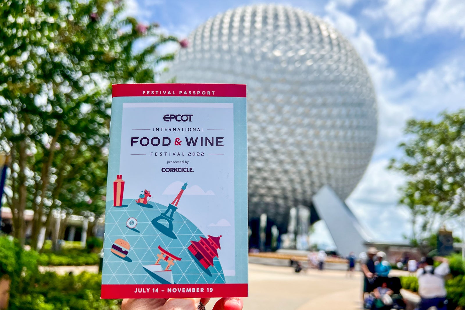 Epcot Food and Wine Festival badge in front of the Epcot entrance