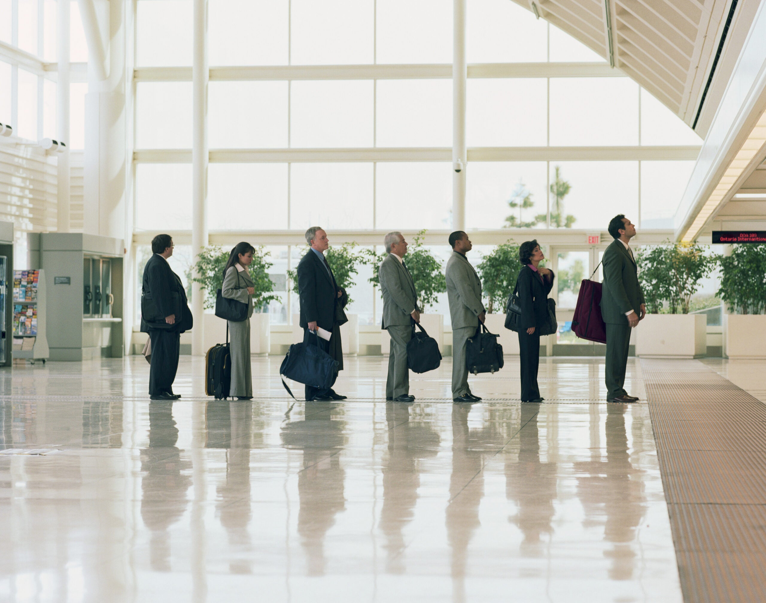 Businessmen and women lining up in airport