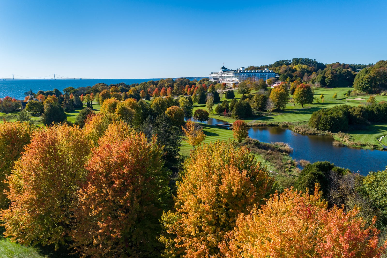 Aerial photo of beautiful golf course with trees changing color in autumn