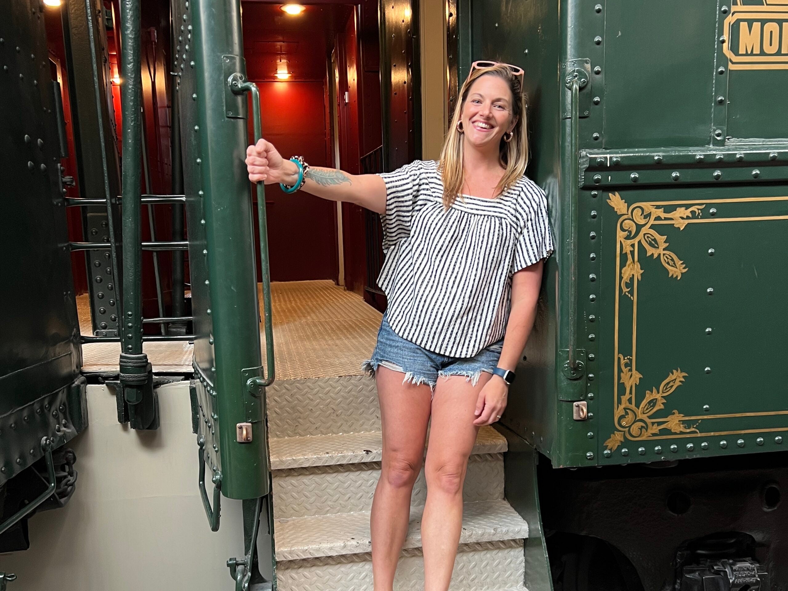 Tarah on stairs to train car room