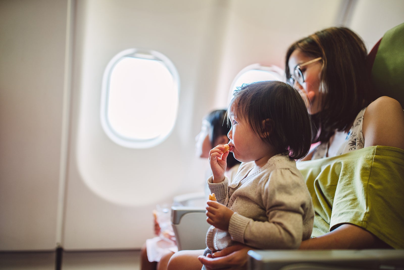 baby on mother's lap on plane