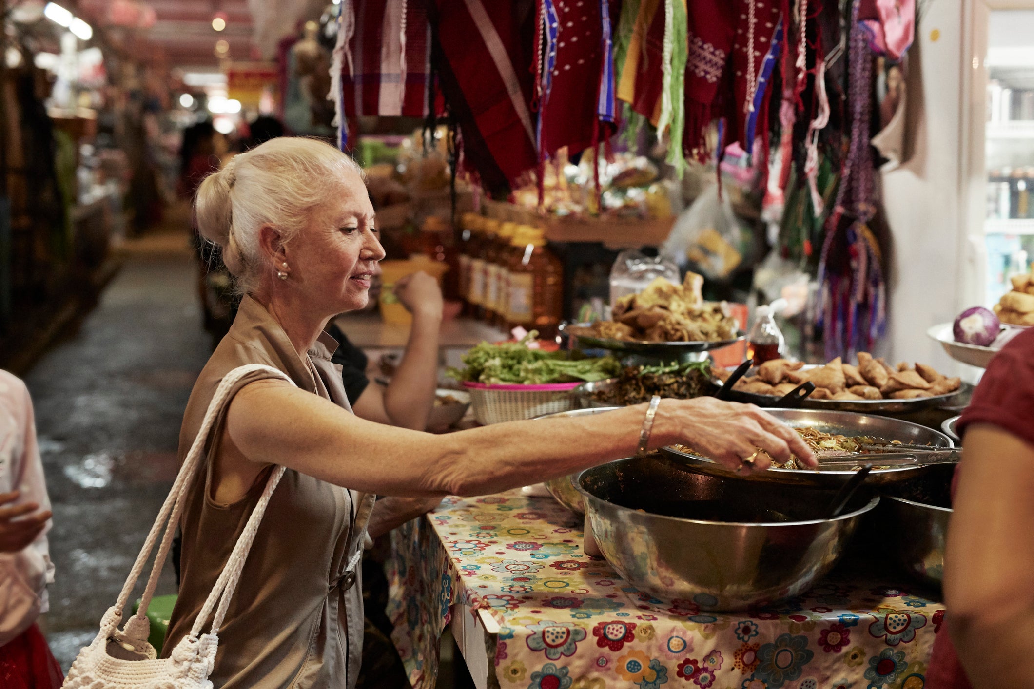 woman chooses food at an outdoor market