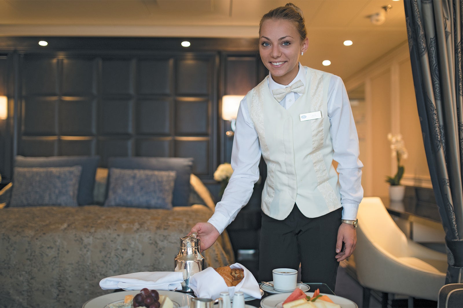 Room steward serving in-suite breakfast on Regent Seven Seas cruise ship