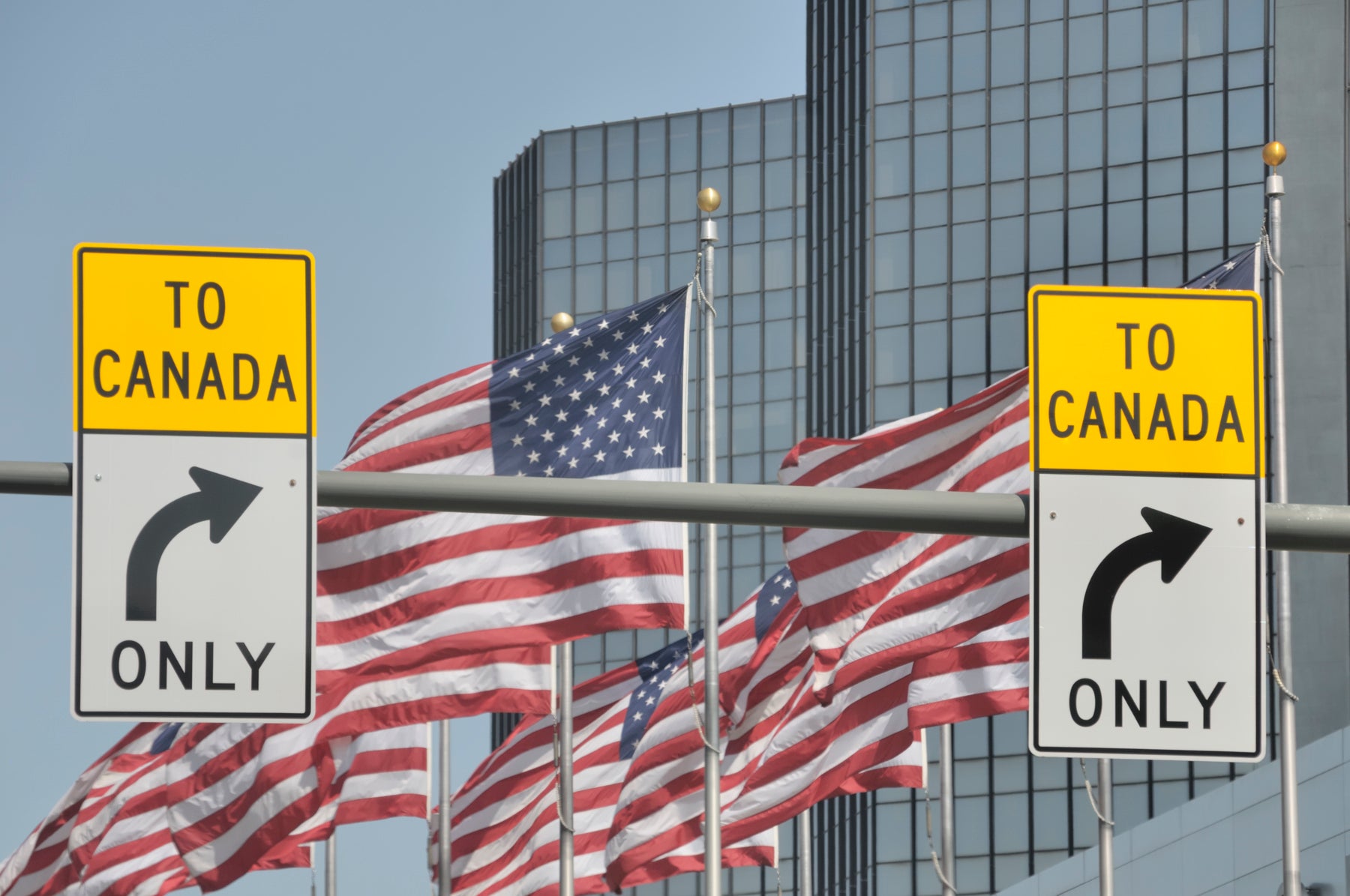 American flags behind to Canada signs