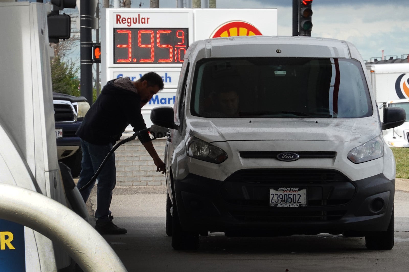 Person filling up a van with gas