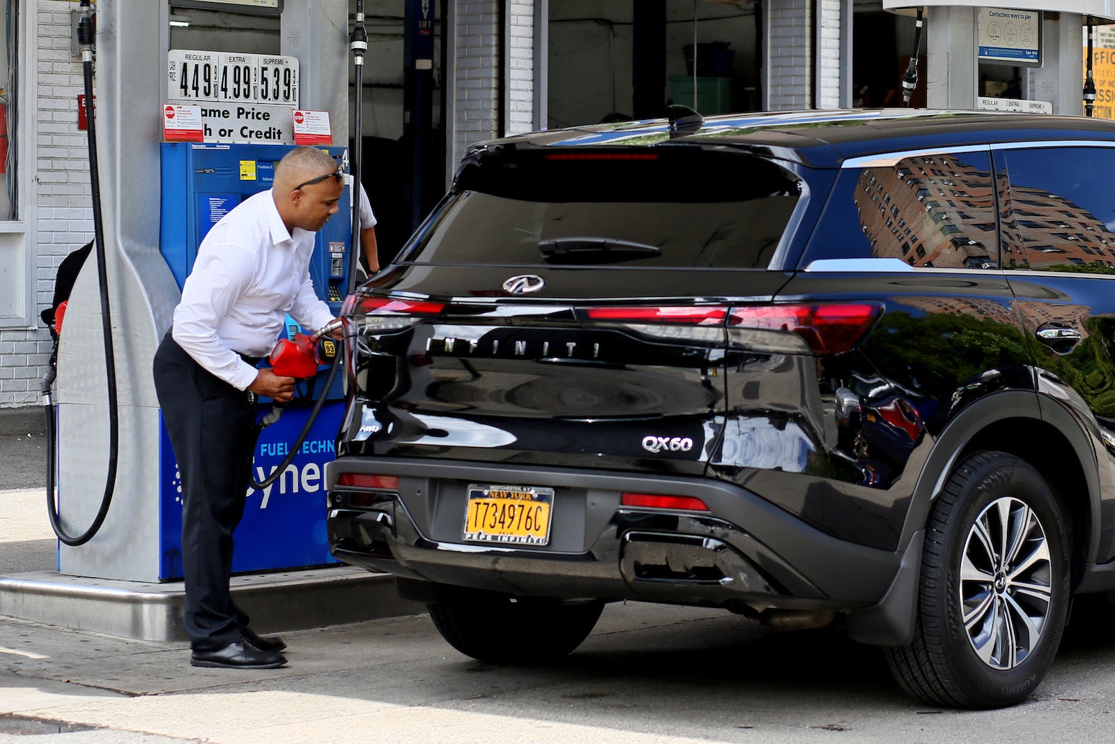 Person filling up an SUV with gas in New York City