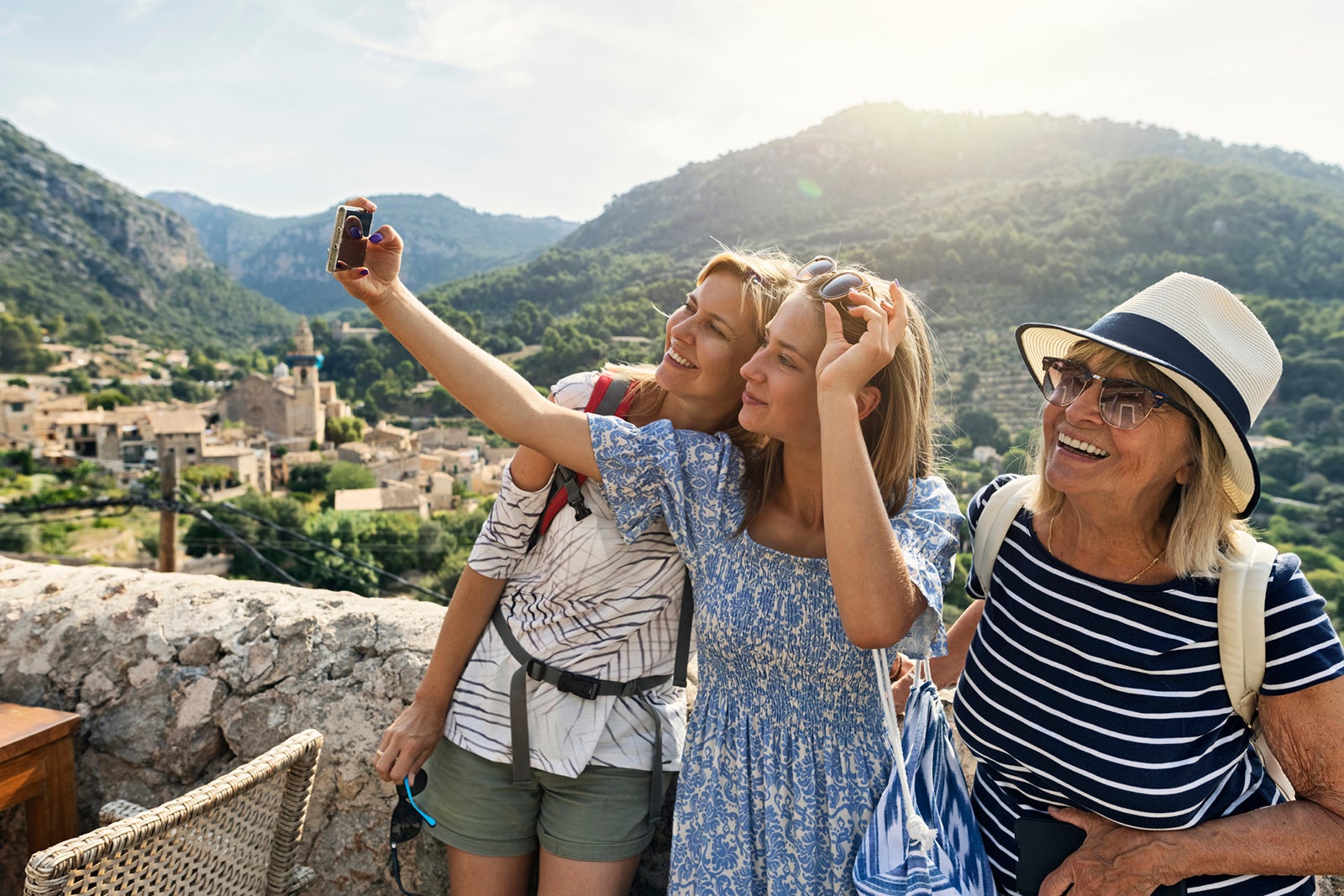 Teenage girl, mother and grandmother are sightseeing beautiful town of Valldemossa, Majorca, Spain